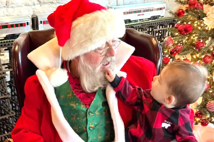 baby tugging at Santa's beard