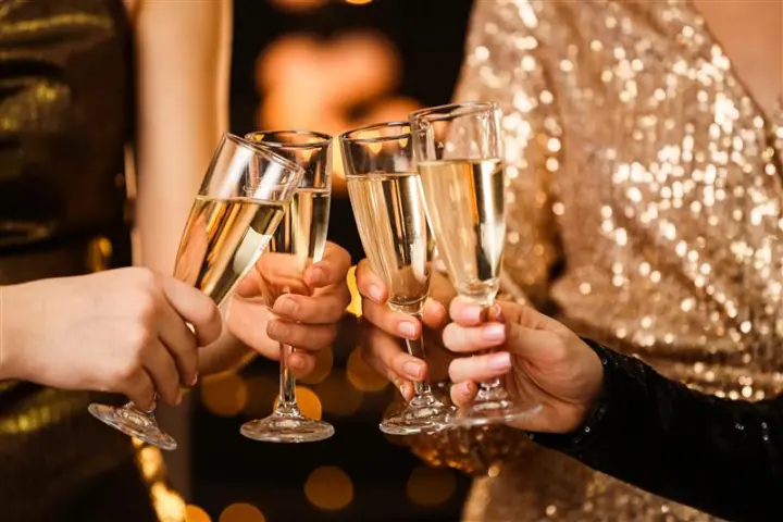 a hand holding a glass of champagne