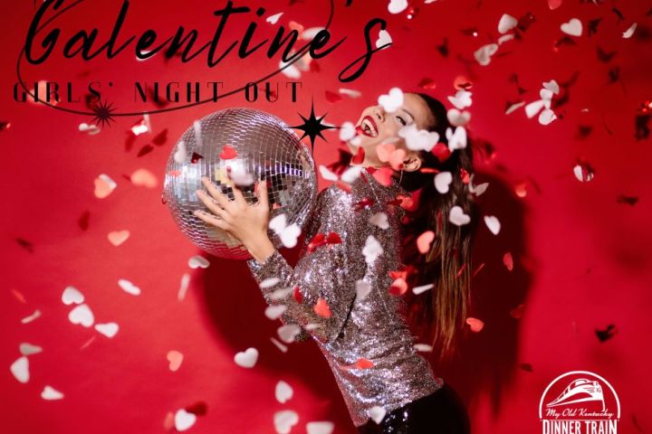 Woman in sparkly dress holding a disco ball with heart confetti on a red background.